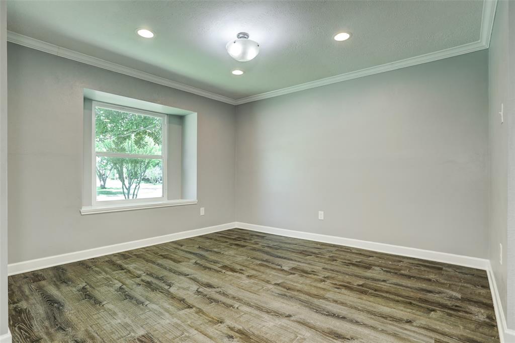 Vacant view of 11x 12 formal dining- crown molding and energy efficient window looks out to front yard