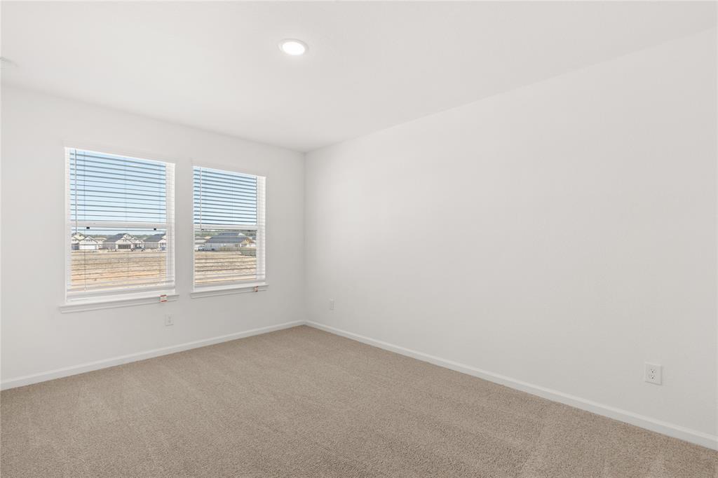 Your secondary bedroom features plush carpet, fresh paint, closet, and a large window that lets in plenty of natural lighting.