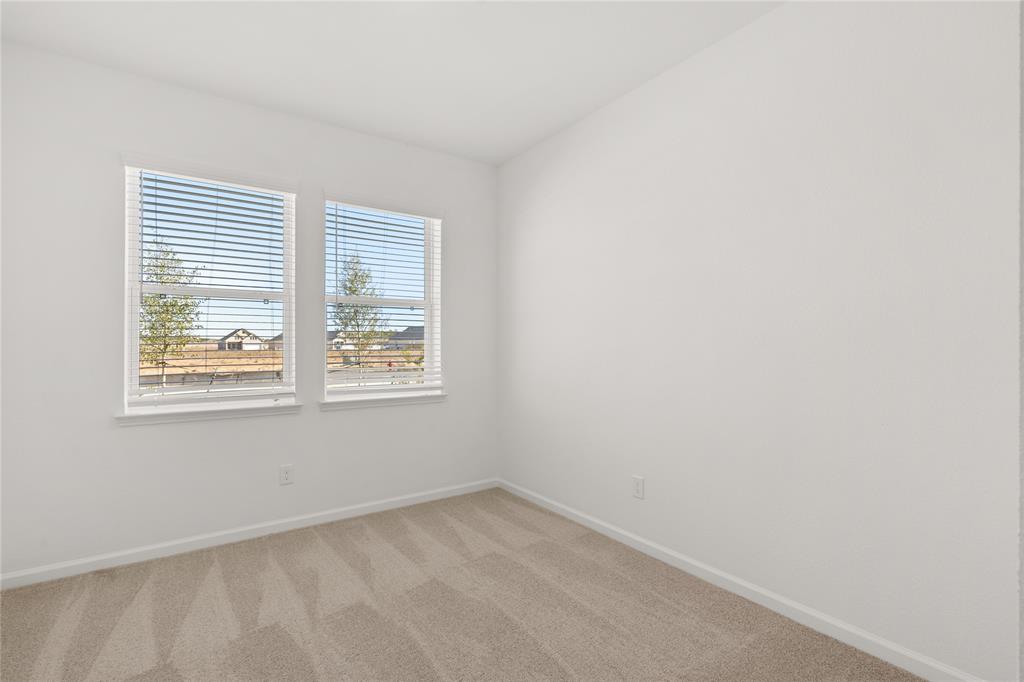 Your secondary bedroom features plush carpet, fresh paint, closet, and a large window that lets in plenty of natural lighting.