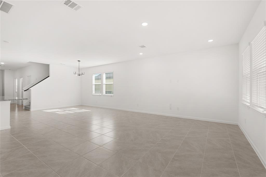 Your family room has ample space to entertain family and friends. This space features beautiful tile floors, fresh paint, recessed lighting and high ceilings.