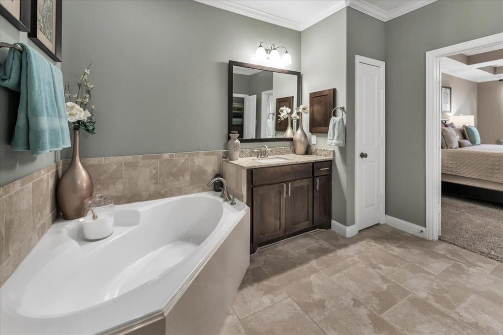 Corner Soaking tub and features seperate vanity areas.