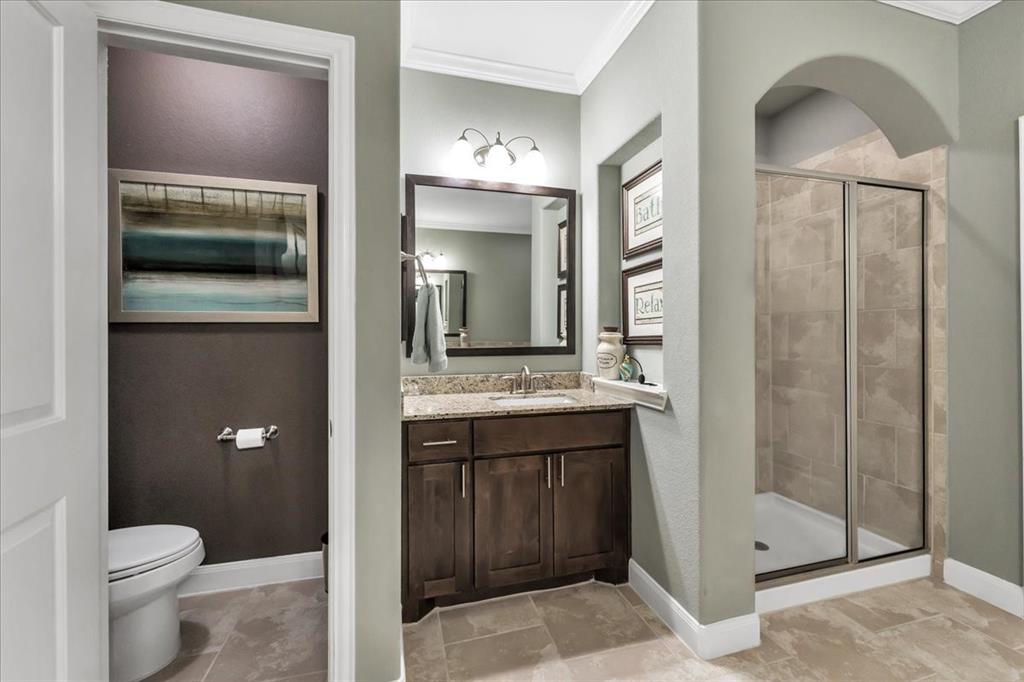 Water closet, one of the vanities and shower