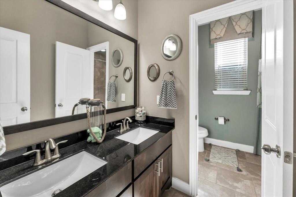 2nd Level -Guest Bathroom features double sinks and seperate wet area with door.