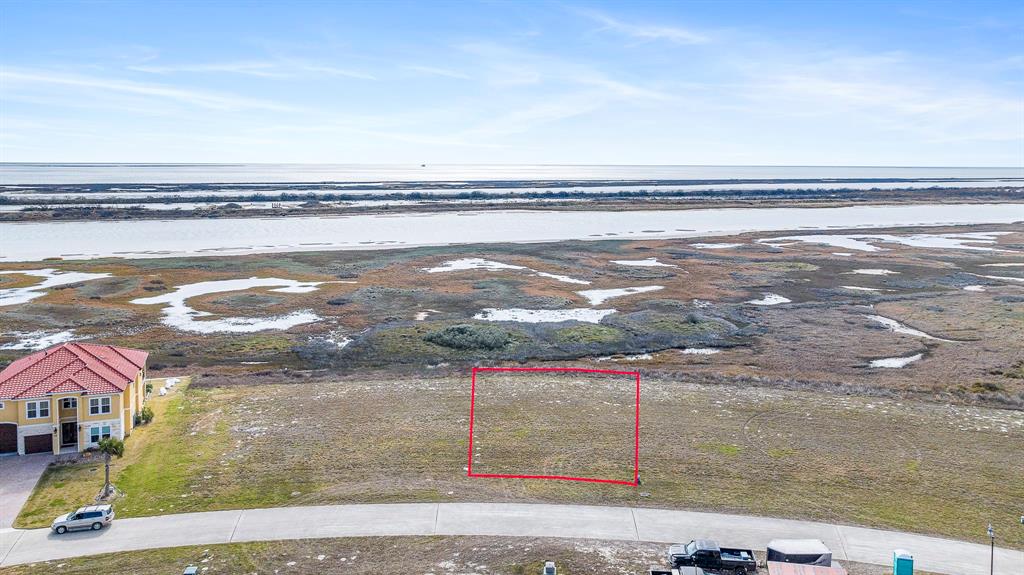 Aerial view of Lot 102 Tuscany Way with approximate property lines and view of ICW, Dewberry Island, and Espiritu Santo Bay