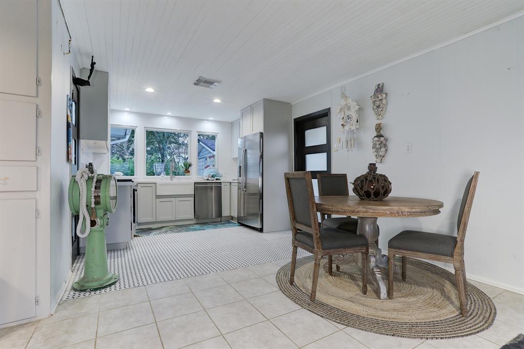 THE KITCHEN COMBINES VINTAGE TILED FLOORS WITH UPGRADED SOFT CLOSE CABINETS.