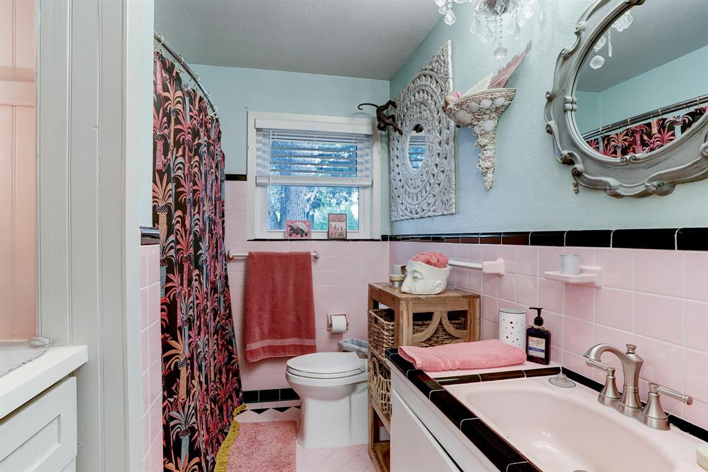 THE FULL BATHROOM IS A VINTAGE GEM WITH TILED HALF-WALL, LINEN BUILT-INS AND TUB/SHOWER.