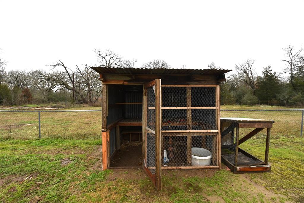 Chicken coup inside the fenced area.