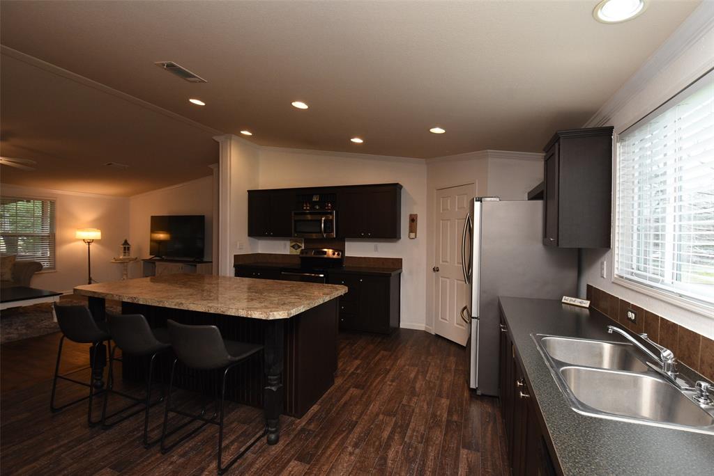 Another view of the kitchen showing the openness. Recessed lighting accent the space well.