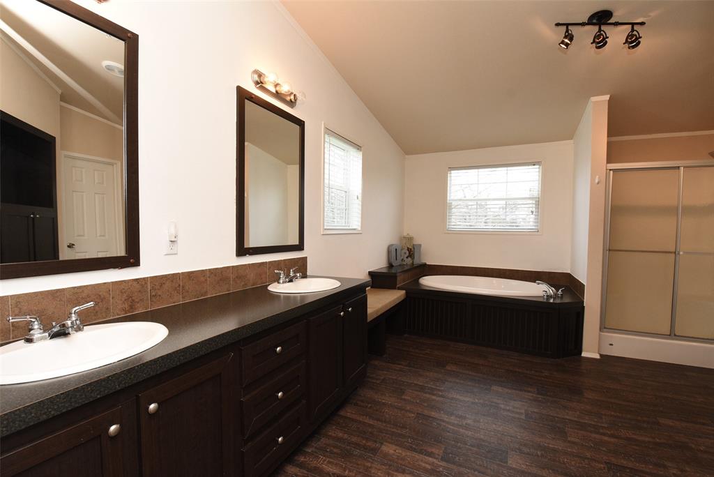 Huge master bath with dual vanities, large tub, and standup shower.