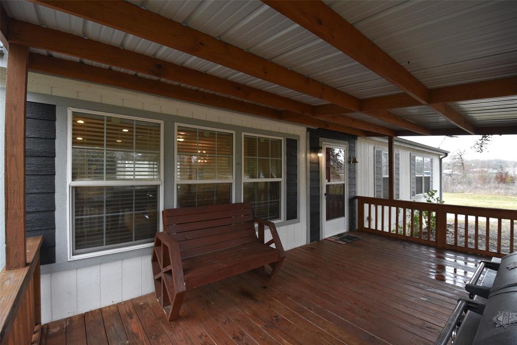 Covered porch leading to entry of home.