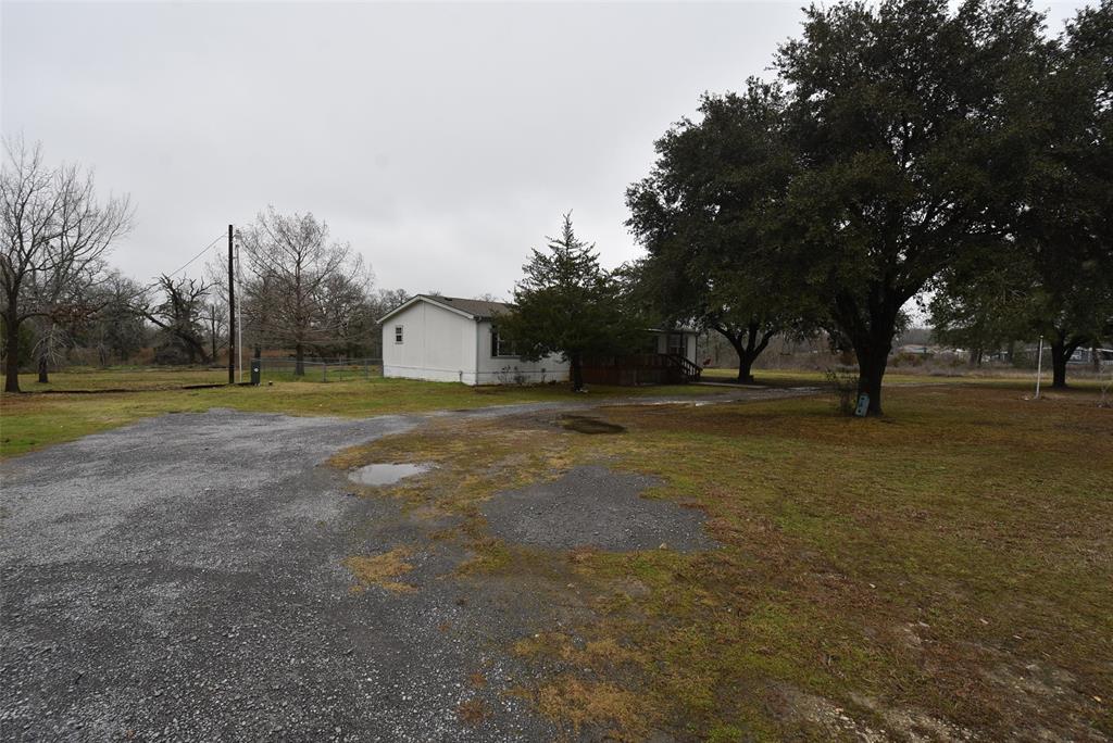 Crushed concrete driveway leading to house