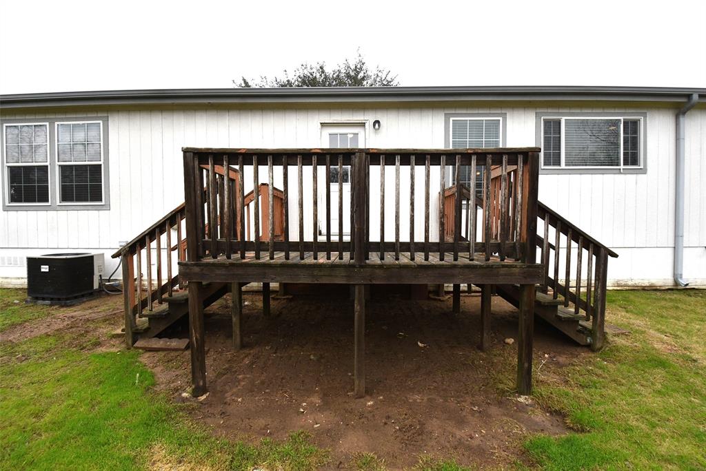 Wooden deck leading from back door to yard.