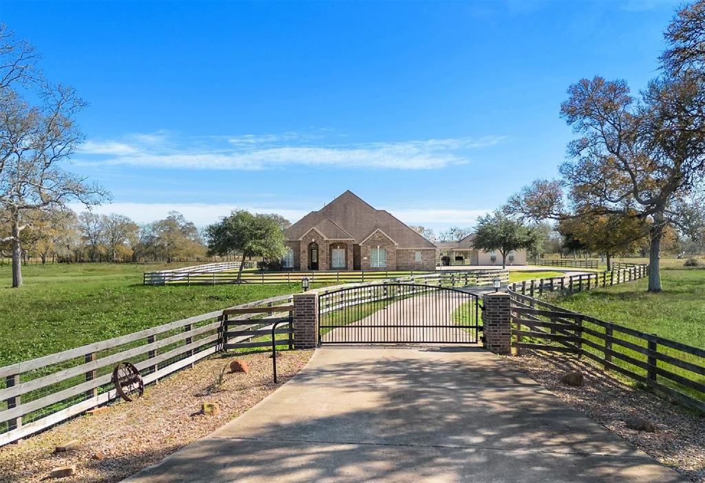 This is the magnificent estate you have been searching for where luxury meets country. Minutes from Sugar Land. Exquisite 4200 sqft showcase home situated on 10 ACRES boasts designer upgrades throughout. Waterfall Pool, Guest House with kitchen and full bath. Barn. Large pond for fishing. Fenced and cross fenced for horses and cattle. Electronic gate access. Designed for large scale indoor and outdoor entertaining. Soaring ceilings, gleaming wood and tile floors granite and more. Expansive great room with fireplace, one of two large living areas. Impressive chefs island kitchen with breakfast bar and breakfast area. Formal dining area with butler’s pantry. Luxurious primary retreat with sitting area features dual vanities, a soaking tub and large shower. Upstairs game room, separate media room and full bath. You must see this incredible home to appreciate all it has to offer. AG exempt. Unrestricted, Low taxes. Do not miss this opportunity to make this home yours!