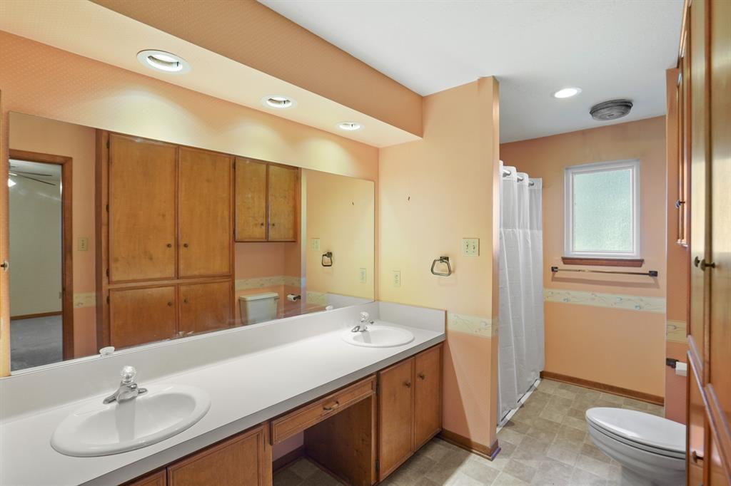 primary ensuite offers double sinks, separate tub and shower and plenty of storage.