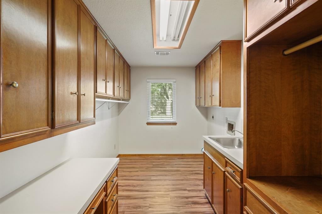 Spacious laundry room with built in desk and plenty of storage space.