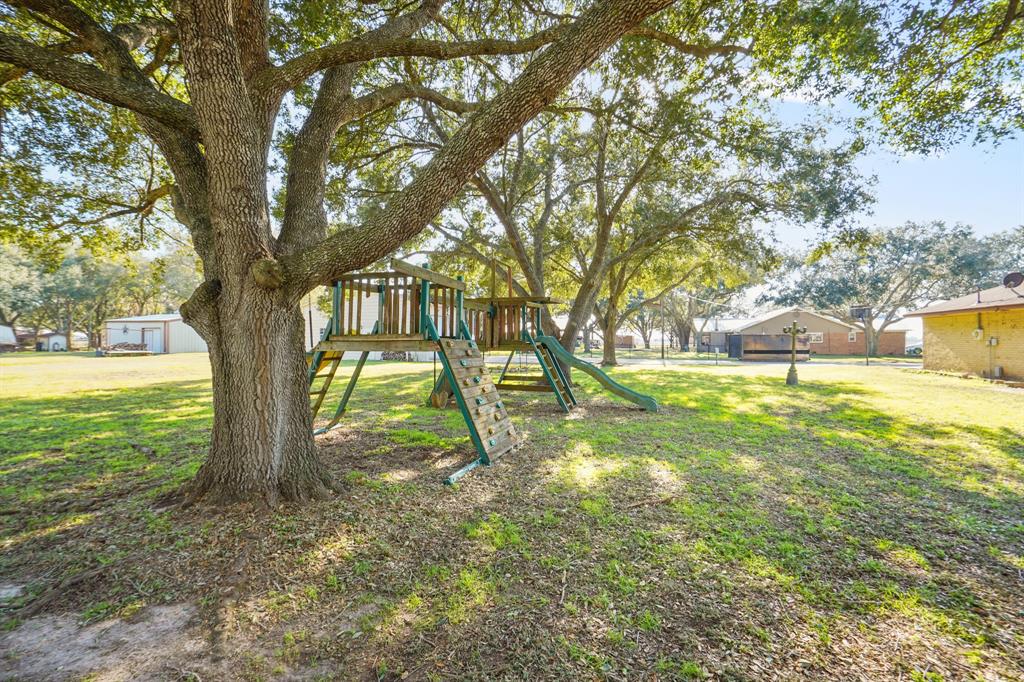 Mature oaks offering plenty of shade in front and back.