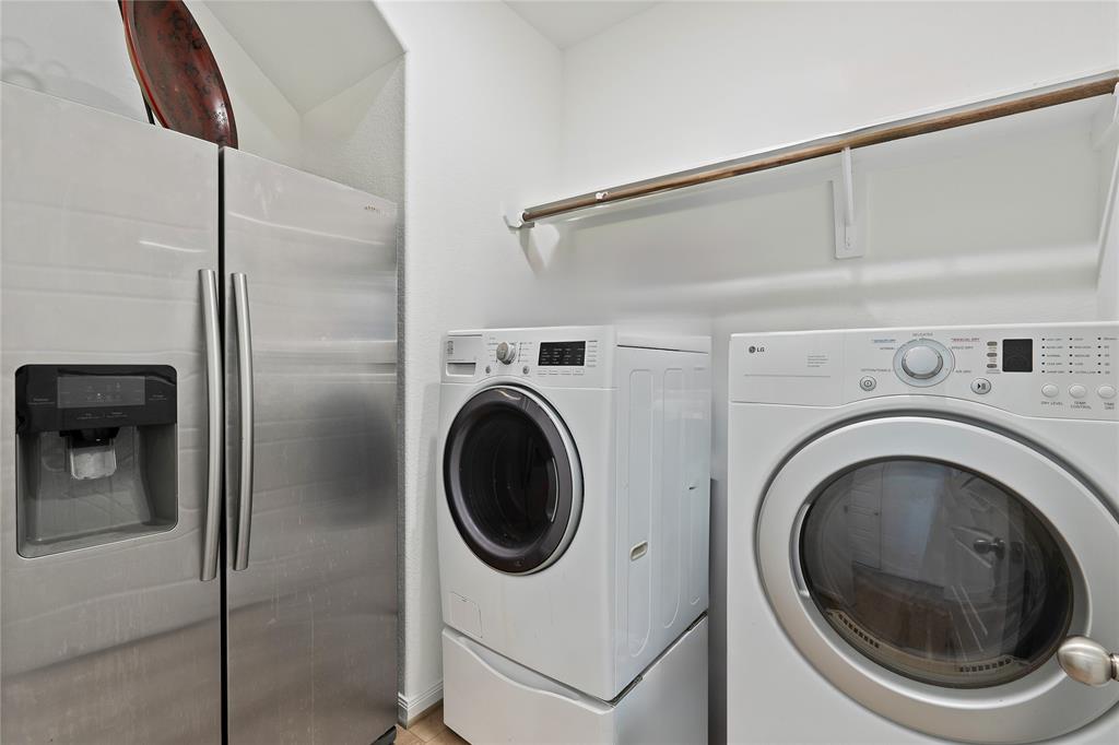 The sizable laundry room can fit two large full size washer & dryer plus a fridge and still roomy to move freely. Plus hanging rods and shelving. on 1st floor conveniently around the corner from the master.