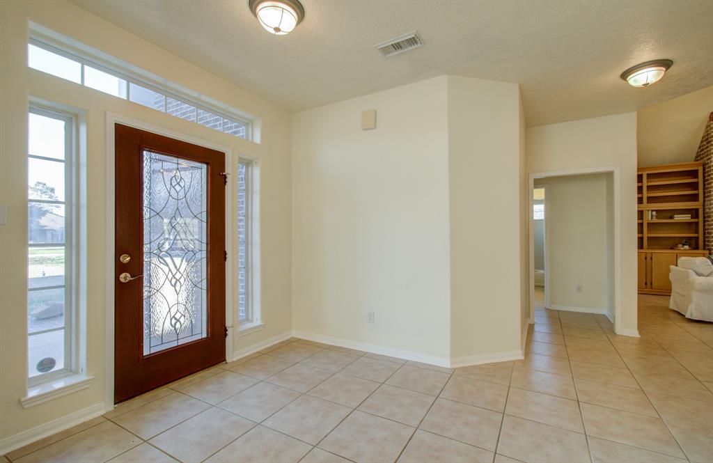 Kitchen with core countertops, island and stainless-steel refrigerator!