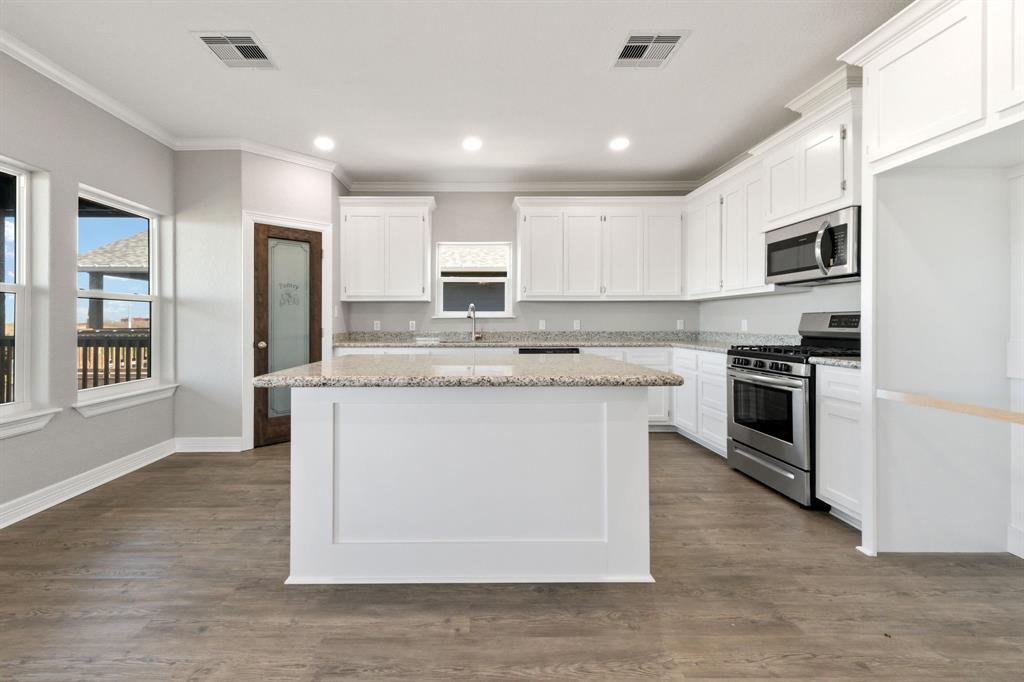 Appealing neutral color palette highlighted by the wall of windows in this spacious kitchen.