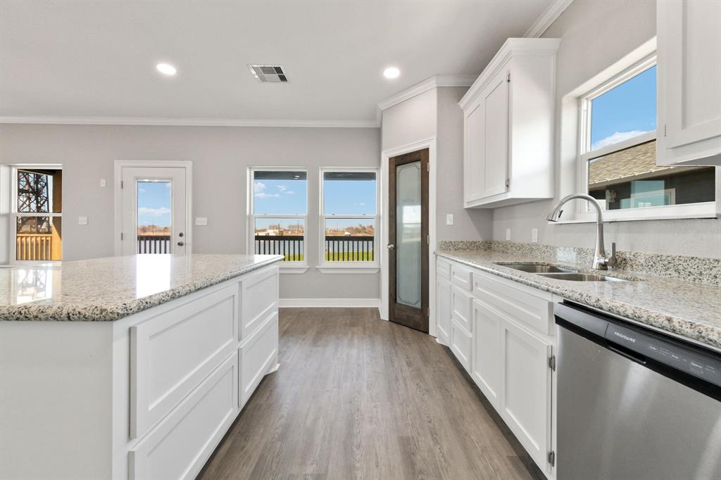 Kitchen features granite countertops, stainless steel appliances, a walk-in pantry & deep drawers in the island for your larger kitchen items.