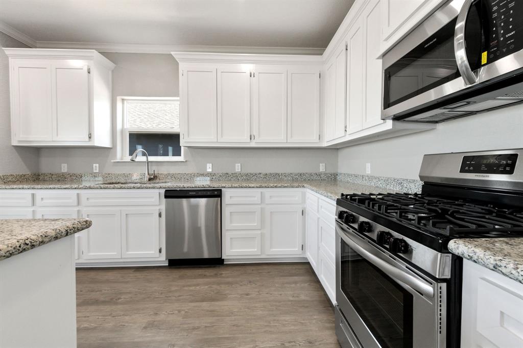 Embrace efficiency and style in this meticulously designed kitchen, where the floor to ceiling cabinets offer organization and functionality, ensuring a clutter-free space.