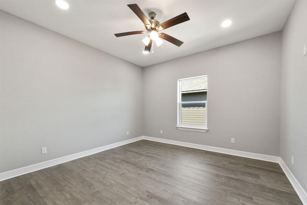 Bedroom 3 featuring high ceilings, crown molding & a walk-in closet.