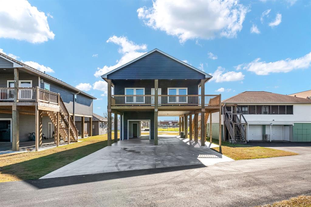 This multi-level property on stilts features 3 bedrooms, 3 full bathrooms & 2 kitchens! A full kitchen upstairs for the main living space + a full indoor/outdoor kitchen & full bathroom downstairs with double garage door access making entertaining a breeze.