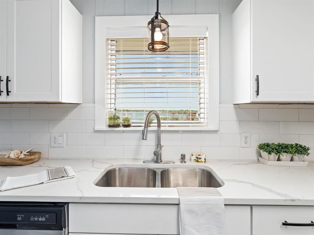 Beautiful granite counters and backsplash gives this such a designer feel.