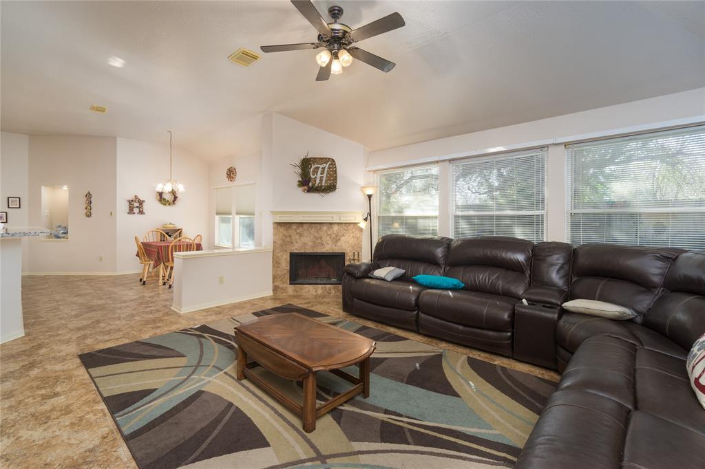 Spacious family room with fireplace is located just off the kitchen and breakfast room.