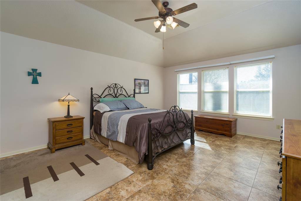 Spacious Primary bedroom features high ceilings, backyard view, 2 roomy walk-in closets (one in ensuite bath)