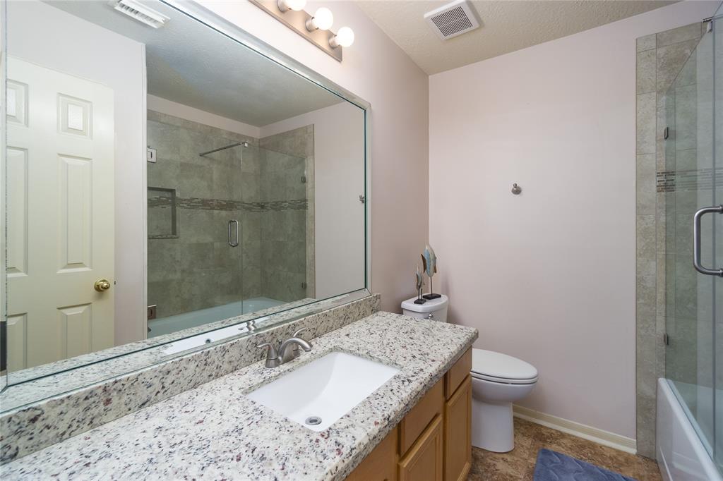 Beautifully updated full bath in the hallway with easy access to secondary rooms, kitchen and other living spaces.