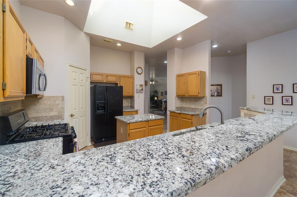 Breakfast bar is just a step away from the breakfast room. Skylight is partially visible here.