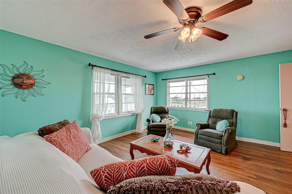 Open living room with natural light and ceiling fans