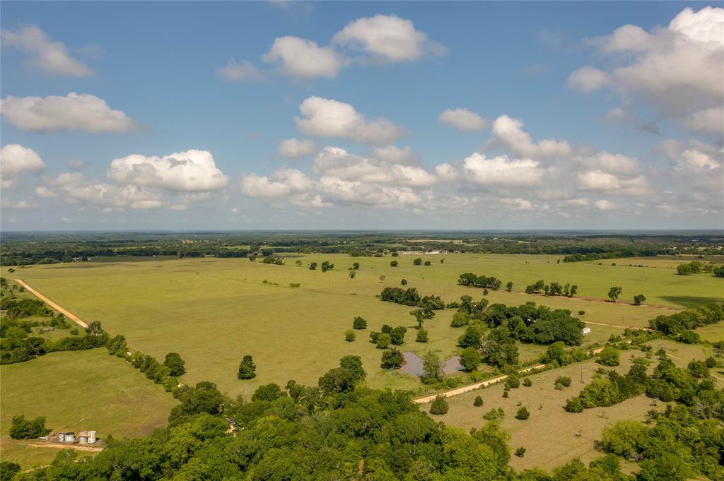 Just minutes from Bryan/College Station, enjoy panoramic views and quiet seclusion on this gorgeous 109 +/- acre ag-exempt tract in Burleson County near Caldwell, TX! Currently utilized for livestock and coastal hay production, the property is equipped with a partially covered barn/working cattle pens that could be expanded to a roping arena or horse training facility. Bordered by CR 318 and acreage properties to the north and west, the property has multiple access points, electricity on-site, a water well (suitable for livestock use only), and a pond. Enjoy this beautiful property as it currently is or build the home of your dreams and still have room to roam!