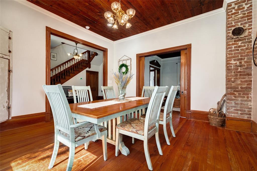 This angle highlights the connecting foyer, dining, and seamless flow into the living room. Notice the original, functional, pocket doors that will offer separation between the two rooms when needed.