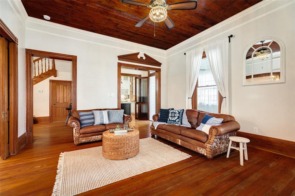 This view of the living room expresses the convenience of the living area to the half bath and the kitchen.