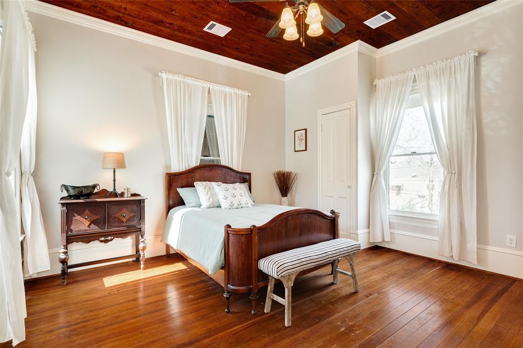 Bedroom 3 features original hardwood floors, large windows overlooking both, the front and back yards, and ample closet space.