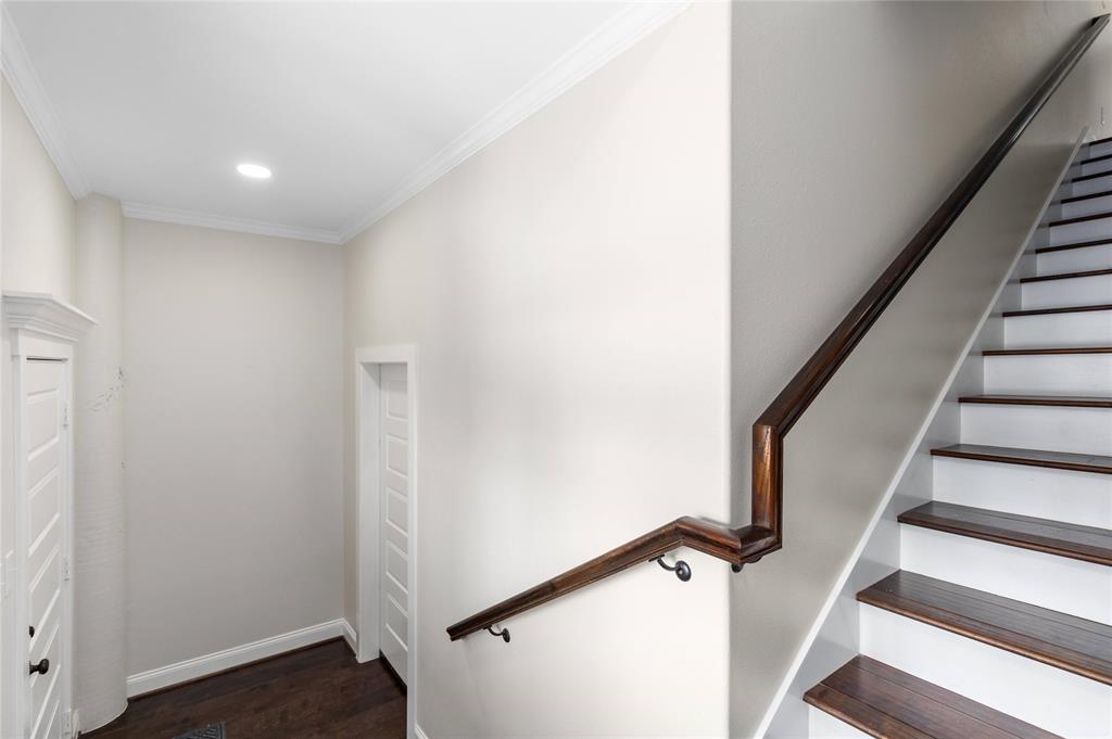 Downstairs landing.  Wood stairs leads to the primary living space.  The door lead to quest quarter apartment or home office.