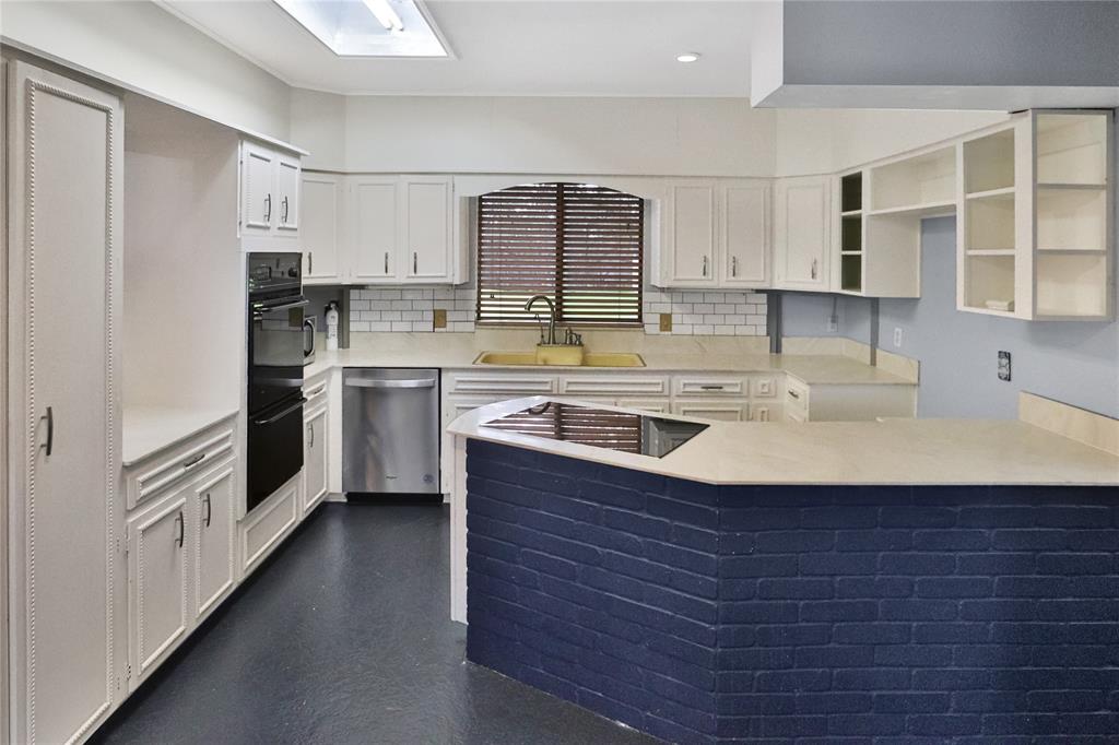 Large kitchen with tons of counter space and custom cabinetry.