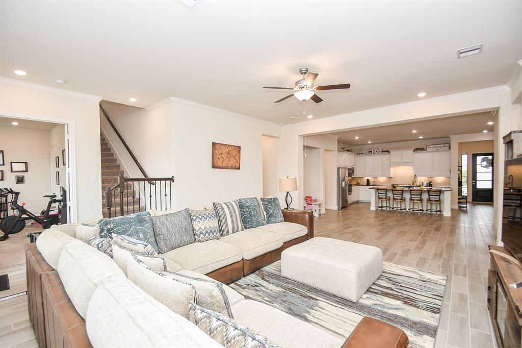 Discover ample living space in this five-bedroom home, enhanced by high ceilings, recessed lighting, and beautiful flooring, creating a delightful atmosphere.