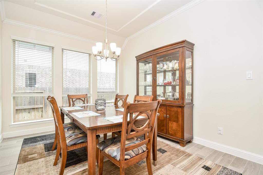 The dining room is beautifully appointed with high ceilings and large windows, crafting an inviting space for those special dinners and memorable occasions.