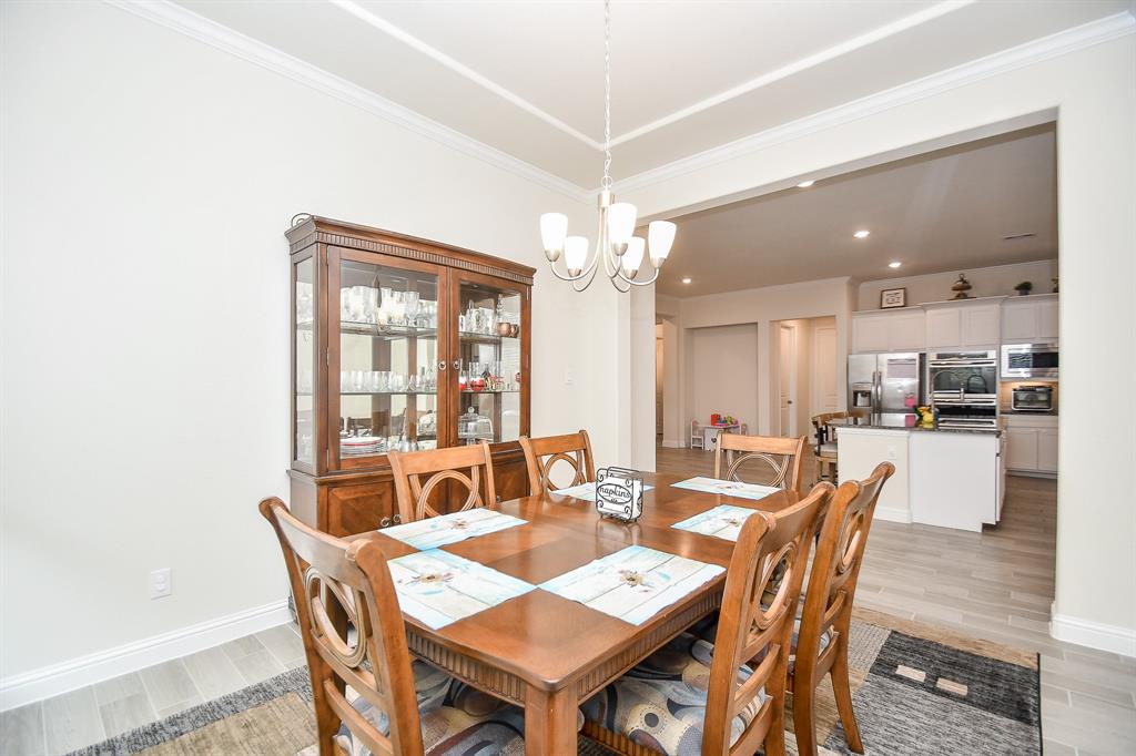 Observe how the dining room effortlessly transitions into the kitchen area and beyond, creating a cohesive and functional living space.