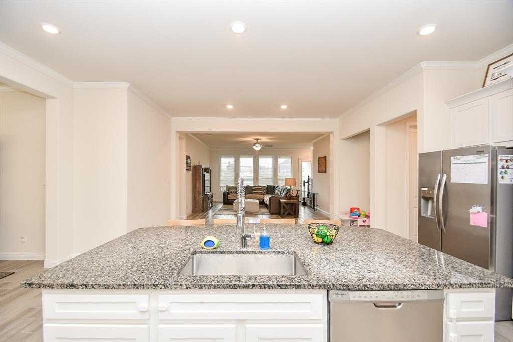 The breathtaking view of the family room from this expansive kitchen island is sure to captivate.