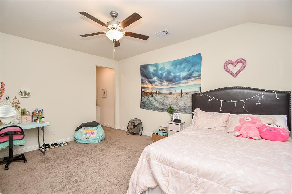 This upstairs bedroom, adjacent to the game room, shares a Jack and Jill bath, offering convenience and privacy for occupants.