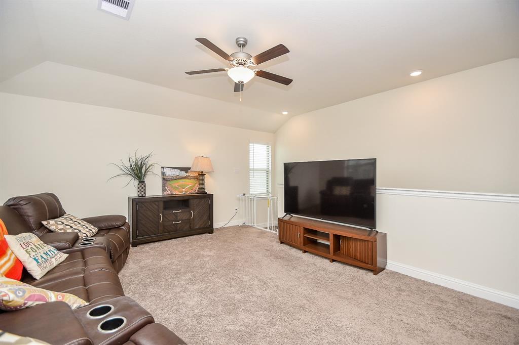 A quick step up the stairs reveals a spacious game room or media room area, perfect for entertainment and relaxation.