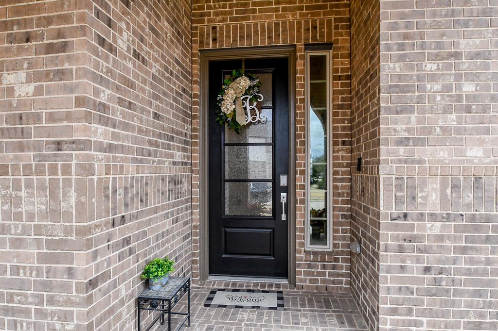 Welcome friends and family with open arms through the inviting front porch and tall doorways of this warm and welcoming home.