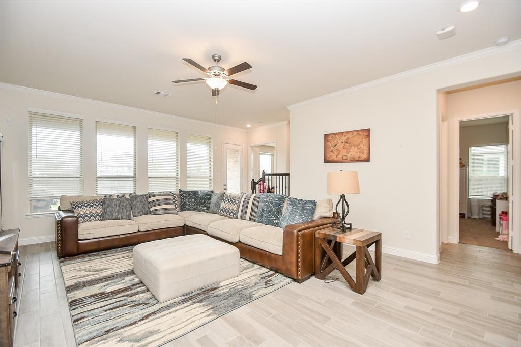 Floor-to-ceiling windows and tall ceilings accentuate this family room, with bedrooms nearby for added convenience.