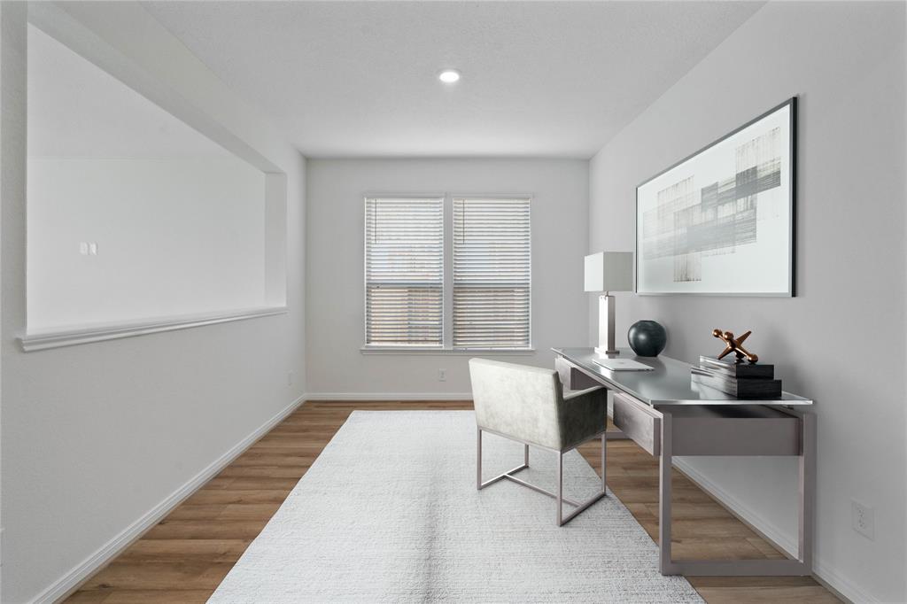 This flex space can be used as a formal dining, office, or den. This room features beautiful flooring, warm paint, recessed lighting, and windows with privacy blinds