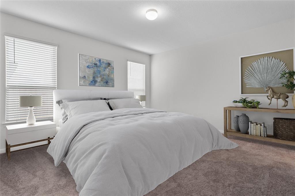 Come and unwind after a long day in this magnificent primary suite! This spacious room features plush carpet, neutral paint, high ceilings and large windows with privacy blinds.