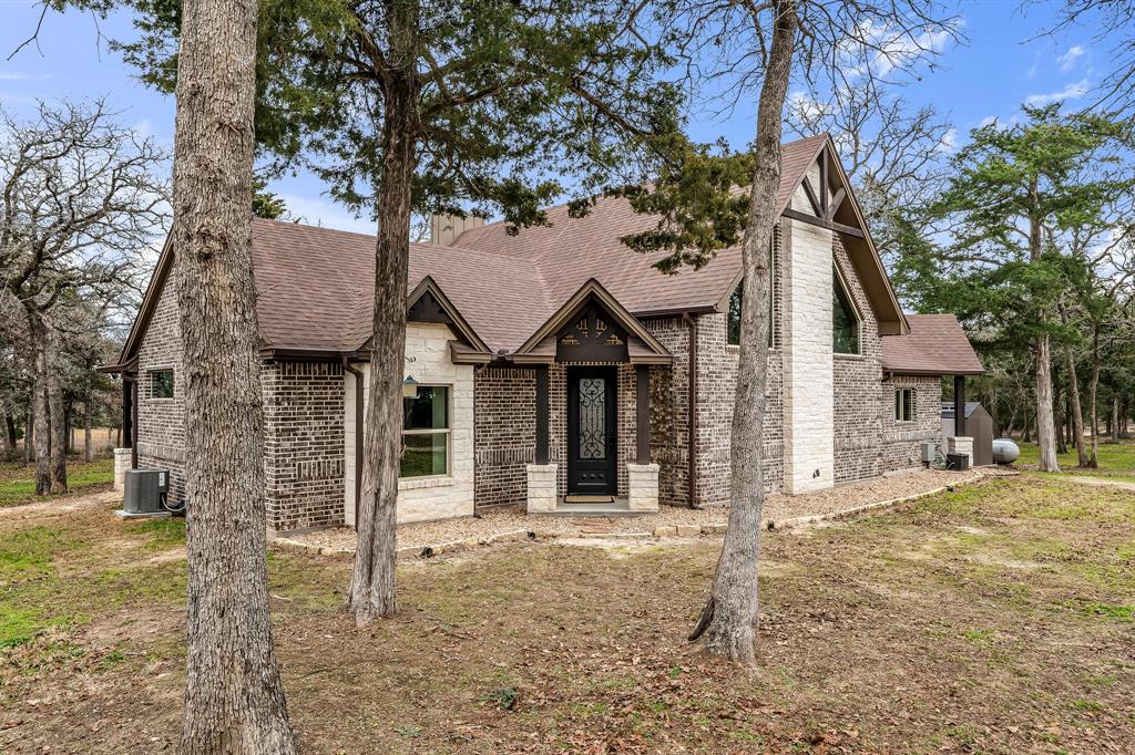 Beautiful Custom home on 20.5 acres in Burleson County in the middle of the rolling hills with lots of trees & amazing views. Open concept welcomes you with designer touches throughout, Great room has cedar beams, tongue and grove-rich stained wood ceilings, Bamboo flooring, Floor to ceiling stone gas fireplace, Venetian plaster walls, Custom trim, French doors. Alder wood barn doors throughout, The Kitchen has Knotty Alder Cabinets, Gas cooktop, New oven, & microwave, Walk-in Pantry, Stainless appliances, Deep farmhouse sink, chiseled edge Granite, Under cabinet & floor lighting, Herringbone brick floors in the kitchen and laundry, Large Laundry w/1/2 bath. secondary bedrooms have full en-suites, The Master offers French doors/natural light, Steam Shower unit with tile/cobblestone floor, walk-in closet, Amazing barn 68x40 x20 high w/3 large doors, 12x40 lean-to  w/14 ft breezeway, Storage, RV Parking secluded & private, RV hookups and cleanouts in 2 locations, pond, New Septic Tank,